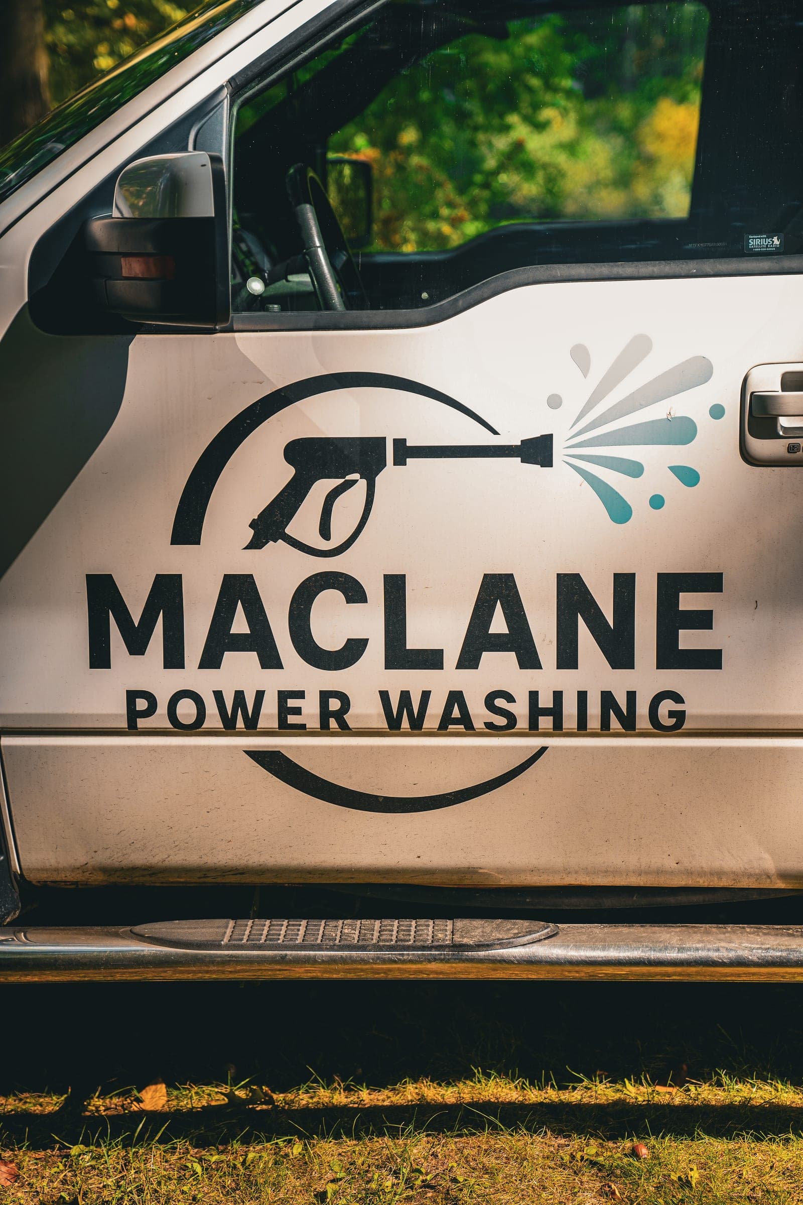 MacLane Power Washing logo on a white truck door