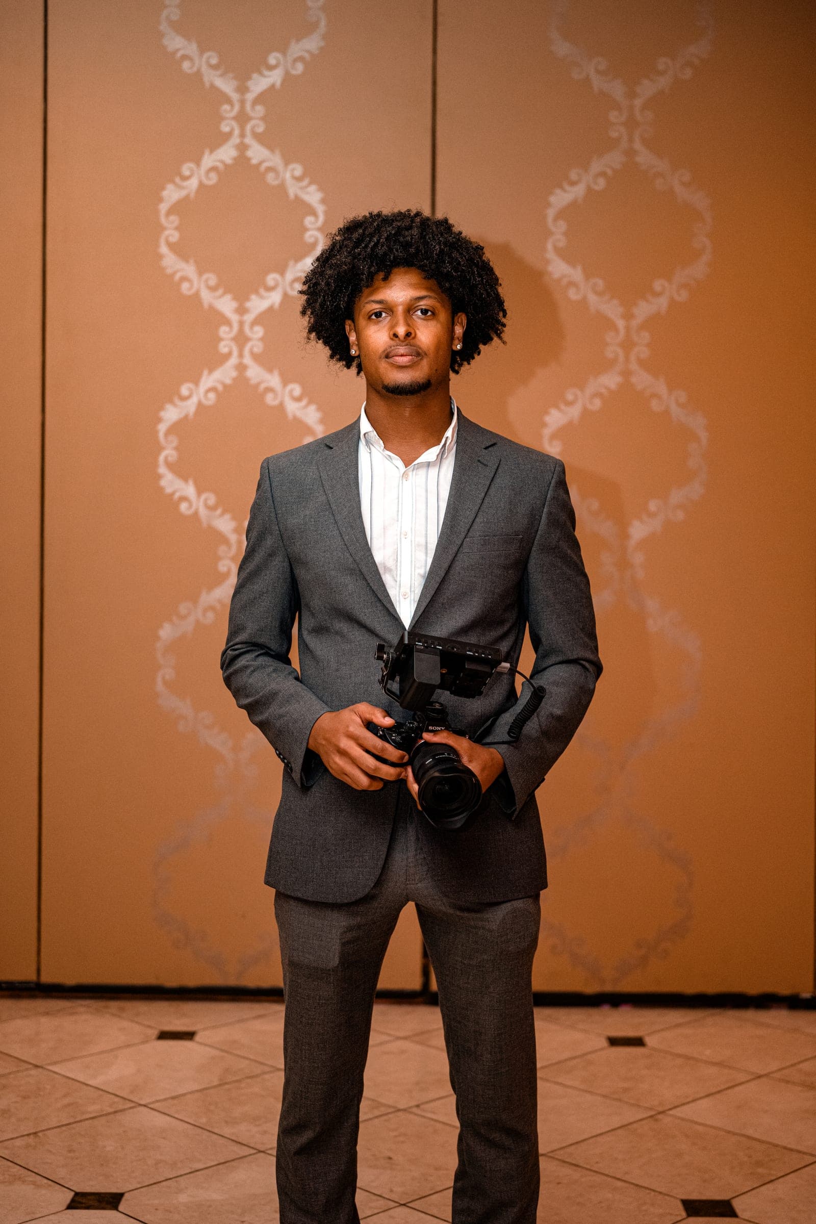 Portrait of Alijah holding a cinema camera