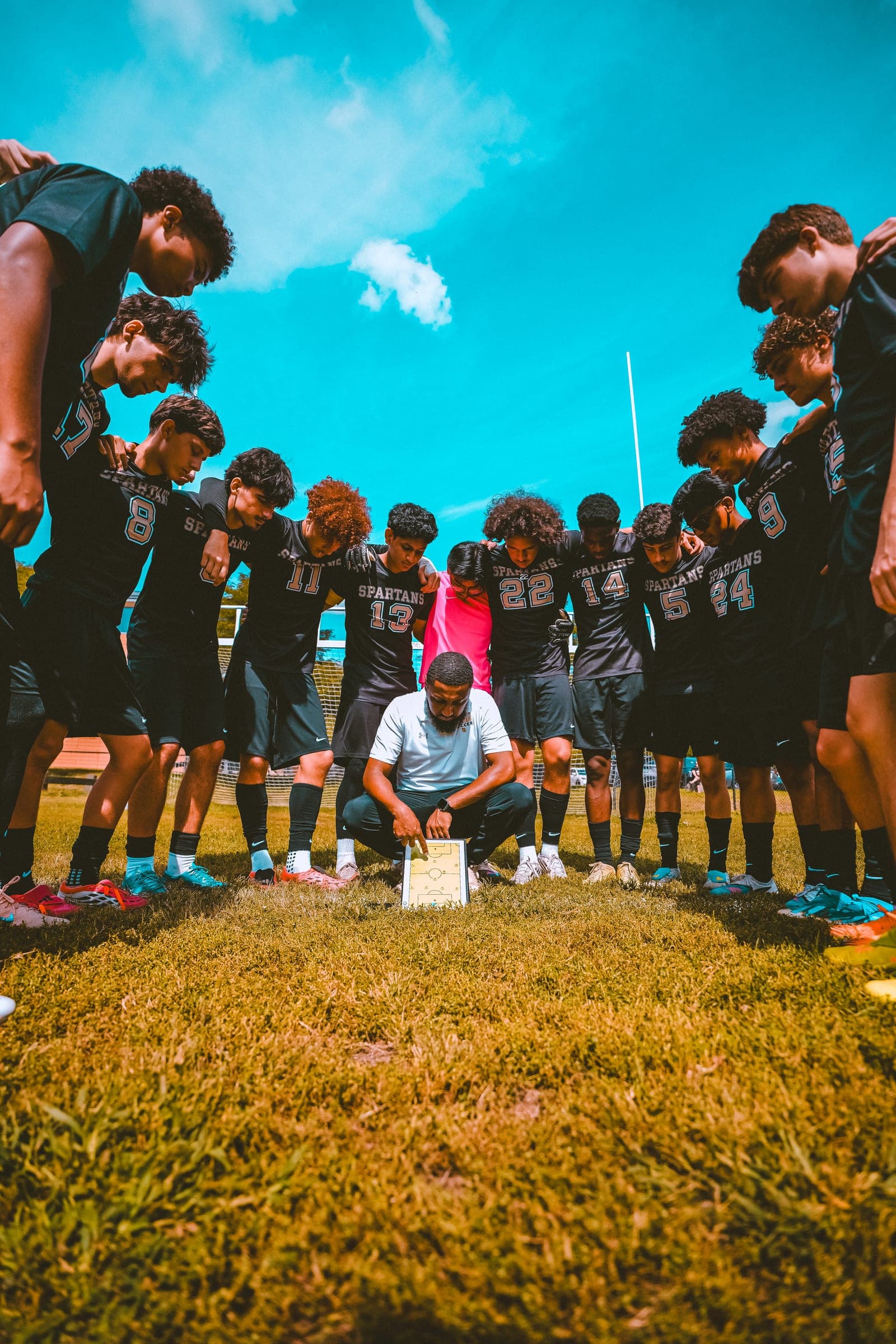 Team huddle seen from ground level